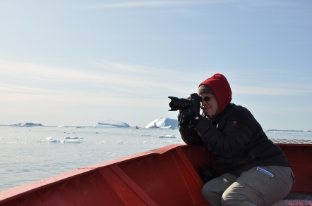 Camille Seaman photographing from a boat (photo courtesy of Camille Seaman)